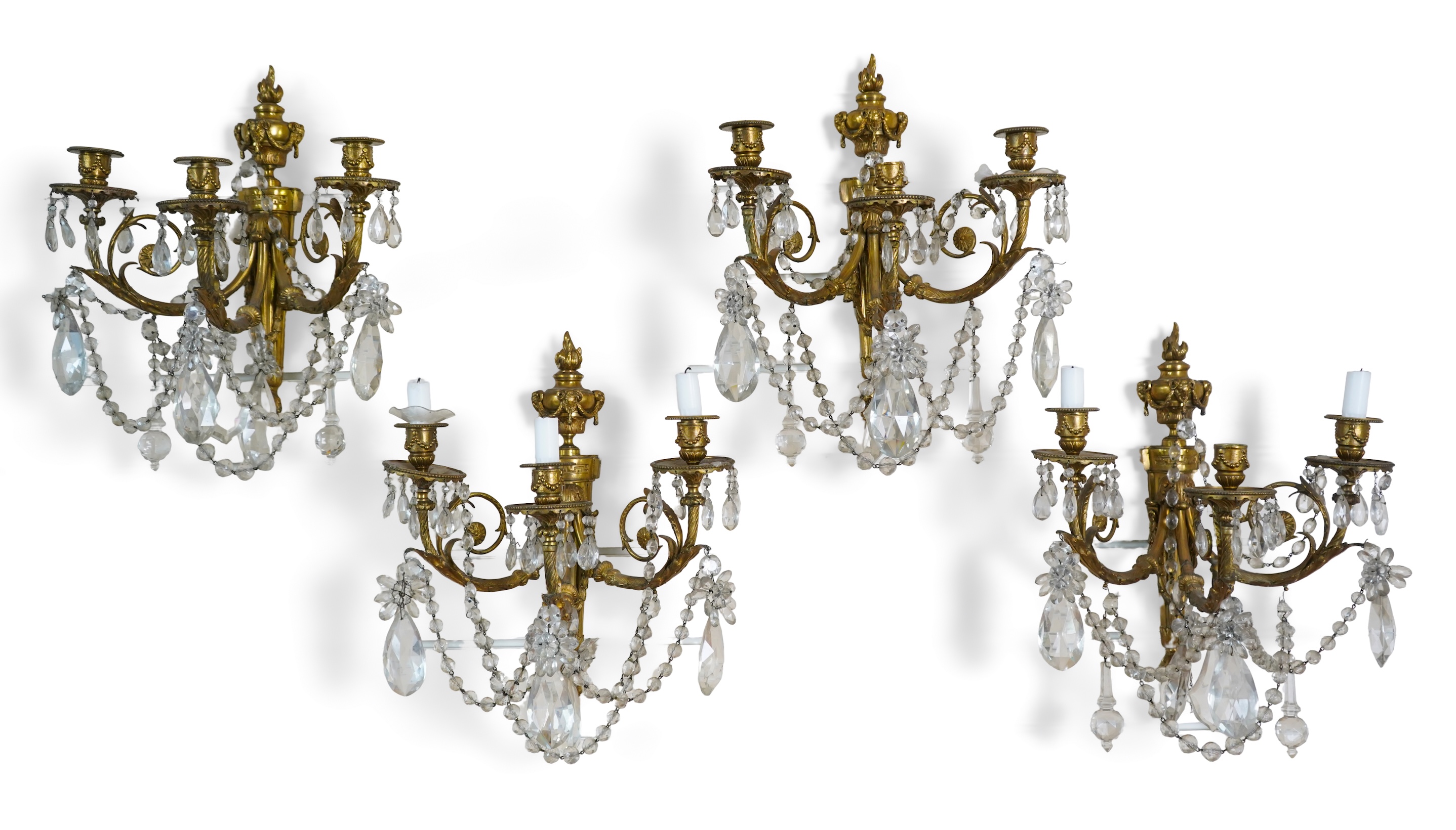 A set of four Louis XVI style ormolu and crystal wall sconces